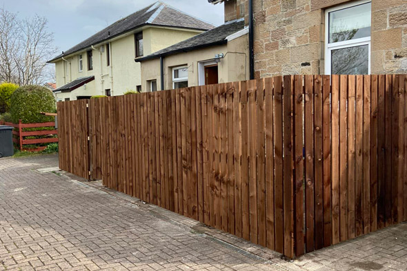 wooden fence surrounding a residential property providing privacy and security in a landscaped area